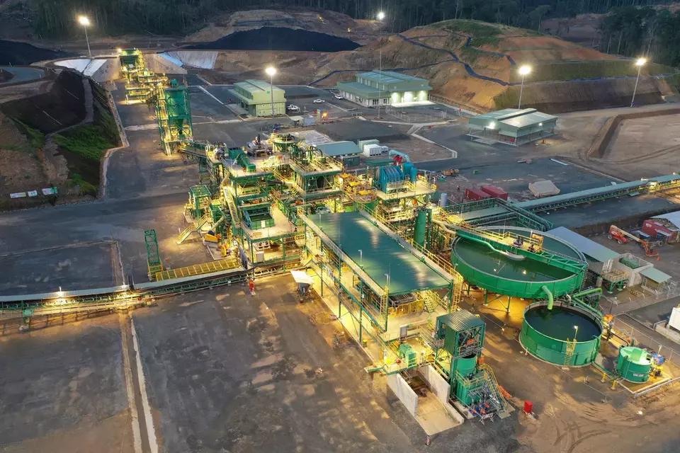 Vista aérea nocturna de una planta de procesamiento de minerales iluminada